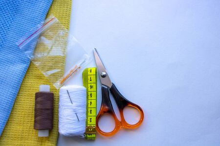 fabric for sewing clothes. Items for sewing clothes. Centimeter tape, tailoring scissors, thread,...