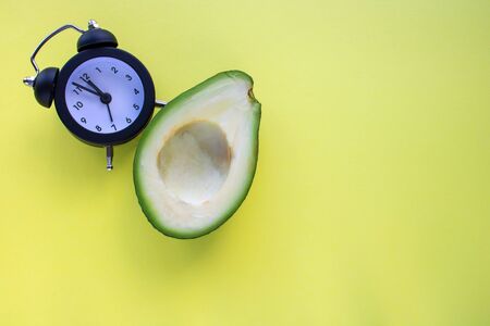 avocado Wake up with alarm clock Breakfast cheerfulness, healthy Breakfast freshness close-upの写真素材