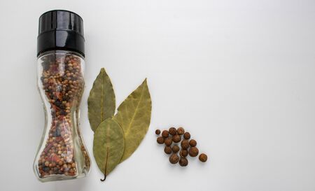 A jar of spices, Bay leaf on a white background in the kitchen.