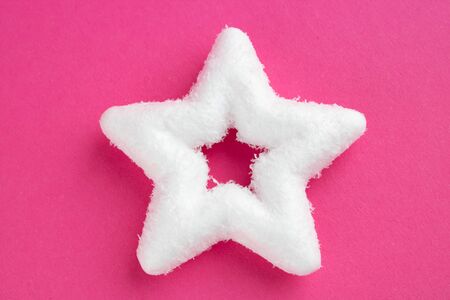 White big star, Christmas tree decoration and holiday decorations isolated on pink background.の写真素材
