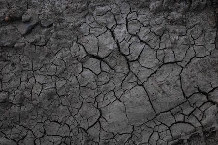 Cracks in the ground due to drought.The concept of global warming. A desolate landscape cracked by...