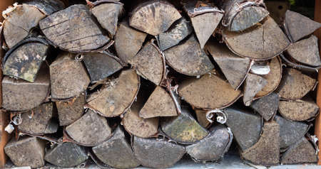 The chopped wood lies in a stack to dry.The background wood