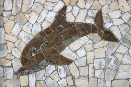 Background of light-colored stone with brown Dolphin. The design of the exterior facadeの写真素材