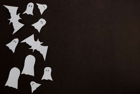 The concept of the Halloween holiday. Halloween decorations, bats, ghosts on black background...