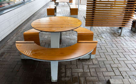Round light brown table, outdoor roadside cafe on an autumn day.の写真素材