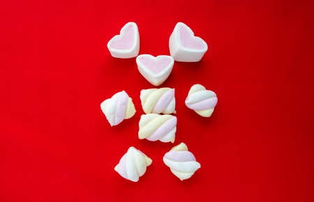 Colorful marshmallow candy isolated on red background.の写真素材