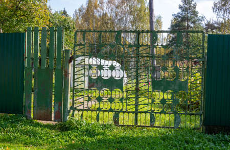 New forged metal double gates for entry of cars into the yard closed.の写真素材