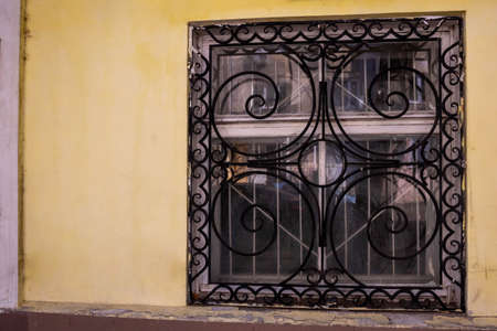 Window with iron openwork wrought iron bars.の写真素材