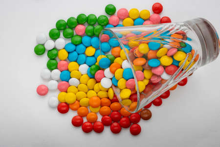 A glass tumbler on a colorful abstract candy background, a copy of the space. Charming texture. Top view, the flat lying.の写真素材