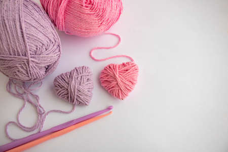 Threads, hooks, and two hearts lay on a white background. Holiday card, background. The concept of Valentine's Day, March 8, Mother's Day. Space for your text.の写真素材