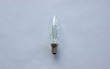Small tungsten light bulb isolated on white background.