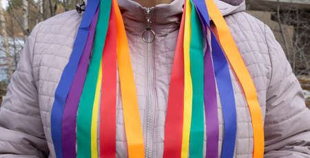 Bright rainbow ribbons hang from her shoulders. Carnival ribbons. LGBT symbol.の写真素材