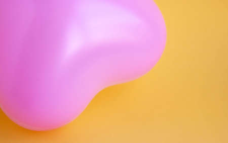 Pink balloon in the shape of a heart on a yellow background. Wedding concept, Valentine's Day, photo zone, lovers. Banner. top view ..の写真素材