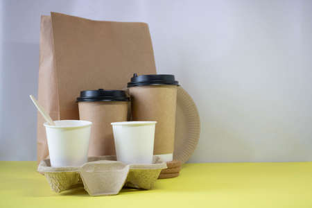Eco-friendly containers ,a paper food bag on a yellow background. Without plastic. Takeaway food....