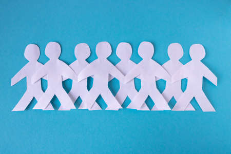 People cut out of paper on a blue background. The concept of the World Peace Dayの写真素材