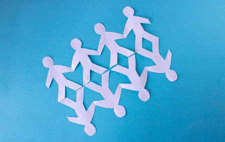 People cut out of paper on a blue background. The concept of the World Peace Day