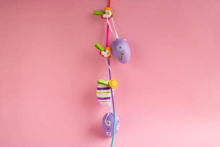 Easter lilac eggs on clothespins on a pink background. easter conceptの写真素材