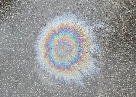 The color diluted with gasoline in a puddle. environmental pollutionの写真素材