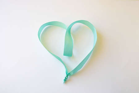 Happy Valentines Day. A heart made of blue ribbon on a white background. Valentines Day Conceptの写真素材