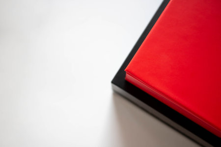 Two boxes red and black in a stack on a white background.の写真素材