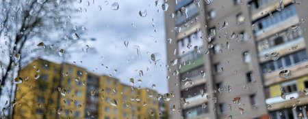 On a cloudy day, raindrops on the car window in the yardの写真素材