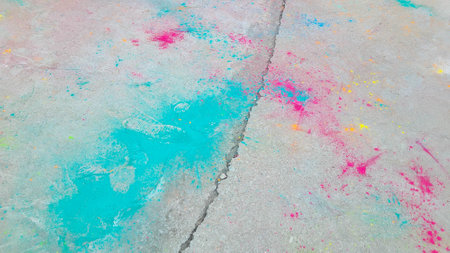 After the celebration of Holi, scattered paints on the asphalt.の写真素材