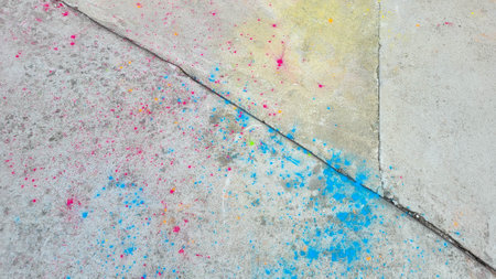 After the celebration of Holi, scattered paints on the asphalt.の写真素材