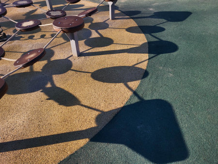 Shadows from the play equipment on the playgroundの写真素材