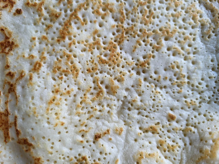 The porous surface of a fried thin pancake