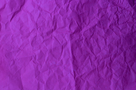 Purple abstract dark background made of crumpled paperの写真素材