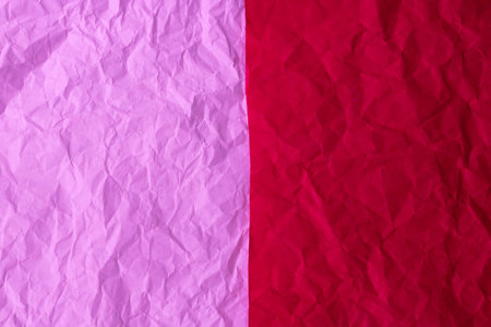 The texture of the background is made of crumpled red and pink paperの写真素材