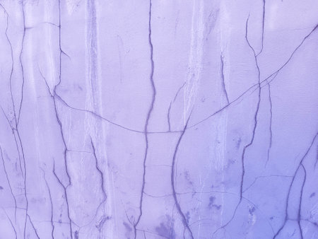 The purple plastered wall of the facade, cracked after the rain.の写真素材