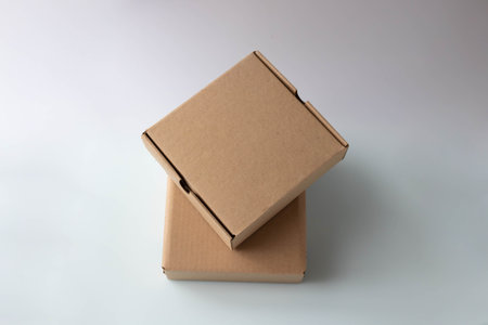 Two brown narrow cardboard boxes on a white background
