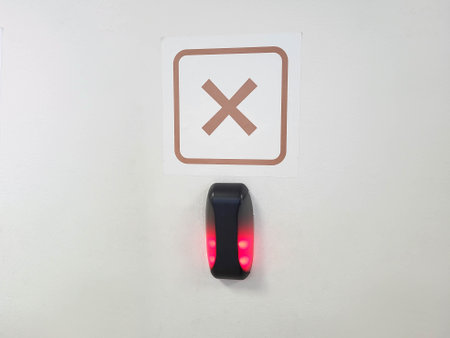 Near the entrance, a contactless card reader is hanging on the wall under the sign of a cross