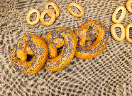 During the celebration of Maslenitsa. There are poppy seed bagels on a table covered with burlapの写真素材