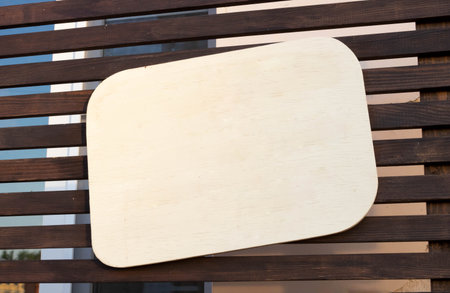 A beige speech bubble is located on brown wooden slats. You can write your text or message here