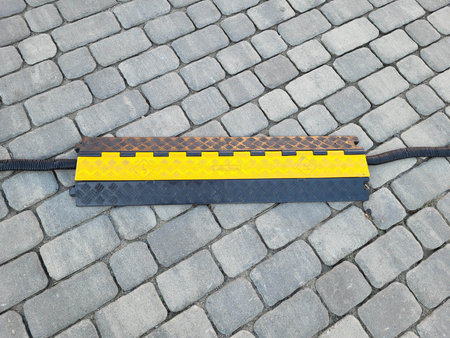 Protecting the cable with a yellow cap on the gray exterior tile.の写真素材
