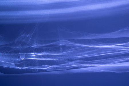 Abstract blue background with sun glare through the glass.