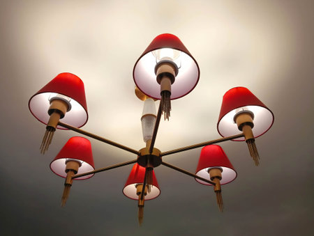 A chandelier with red shades glows from the ceiling.