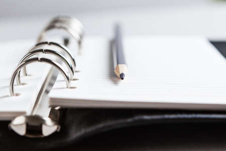 Pencil on the background of the Notepad. Focus on the tip.の写真素材