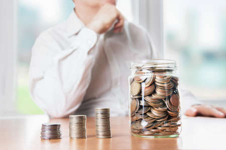Money in a glass jar. The economic growth. Business management. Accumulation of capital.の写真素材
