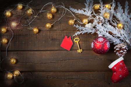Christmas wooden background new year toys, gifts, fir tree in the snow. Symbol of house.の写真素材