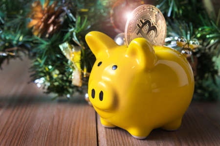 Christmas, New Year, a piggy bank with coins. Gifts on the table. Buying a house.