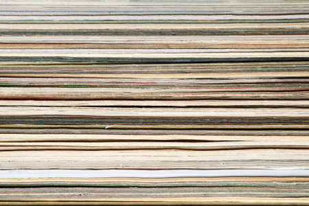 The texture of Newspapers and magazines as a background, side view.