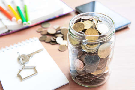 The coins are stored in a glass jar to accumulate finances.