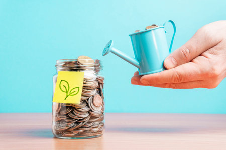 The coins are stored in a glass jar to accumulate finances.の写真素材