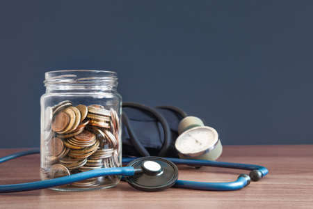 The coins are stored in a glass jar to accumulate finances.の写真素材