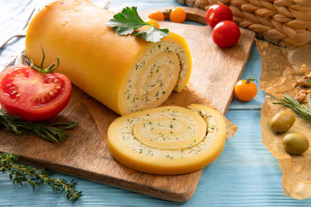 Cheese on a wooden background on the table with different ingredientsの写真素材