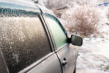 Car covered with ice crust after icy rainの写真素材