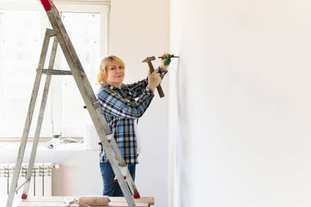 Woman Builder in the room of the house making repairs.の写真素材